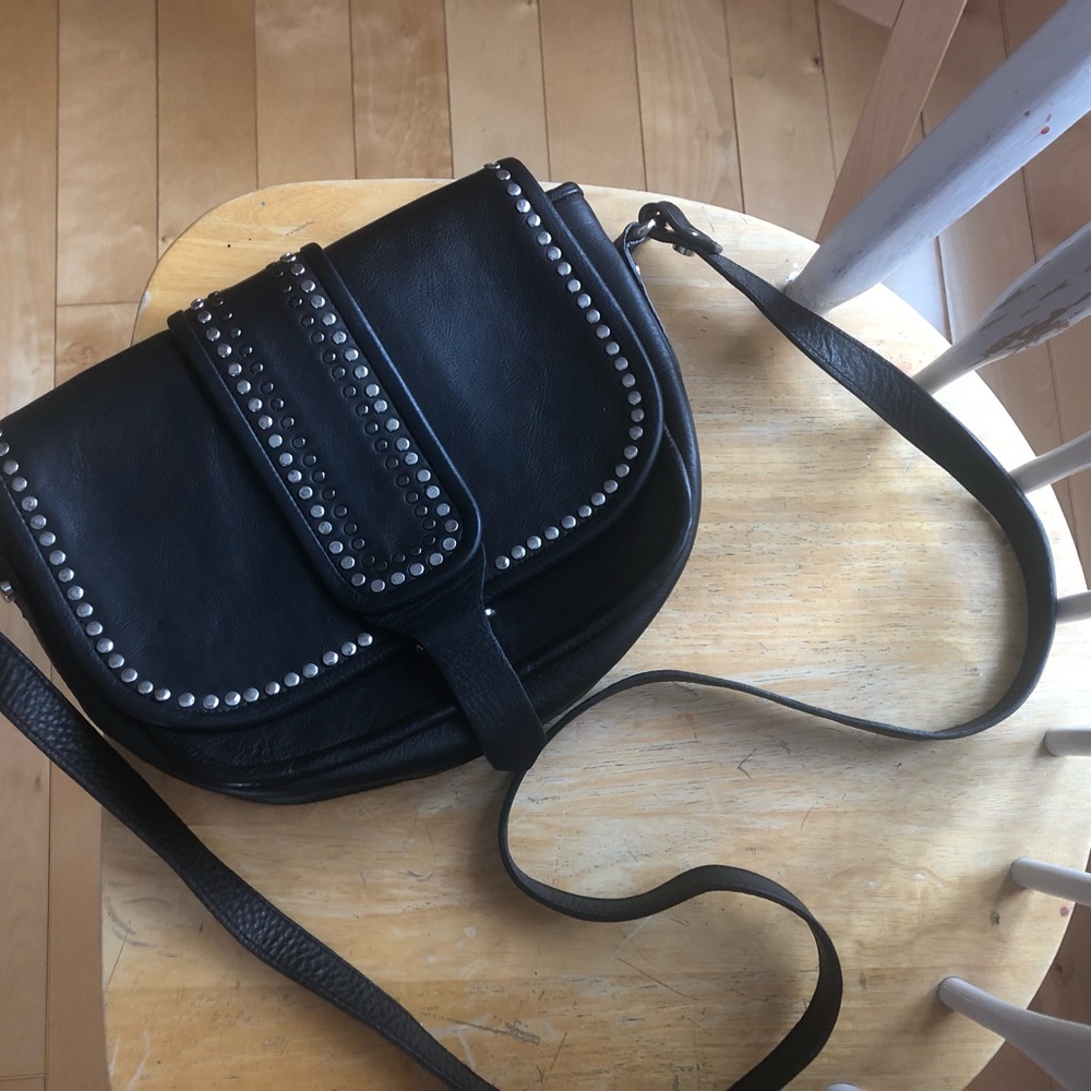 NWT Black with silver metal studs. Long leather strap, adjustable.